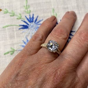 Faux diamond engagement ring set in light gold tone. Size 6 1/2